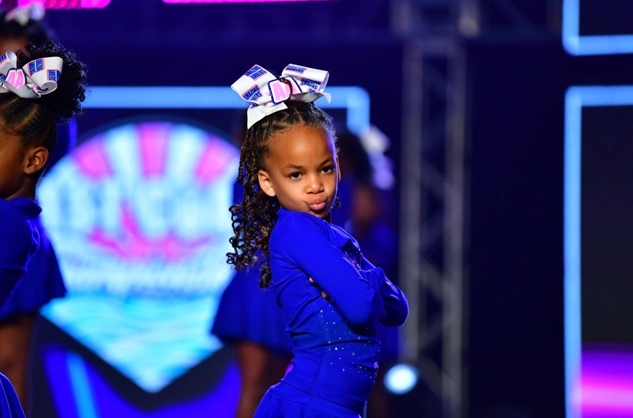 Young JCG athlete performing confidently on stage